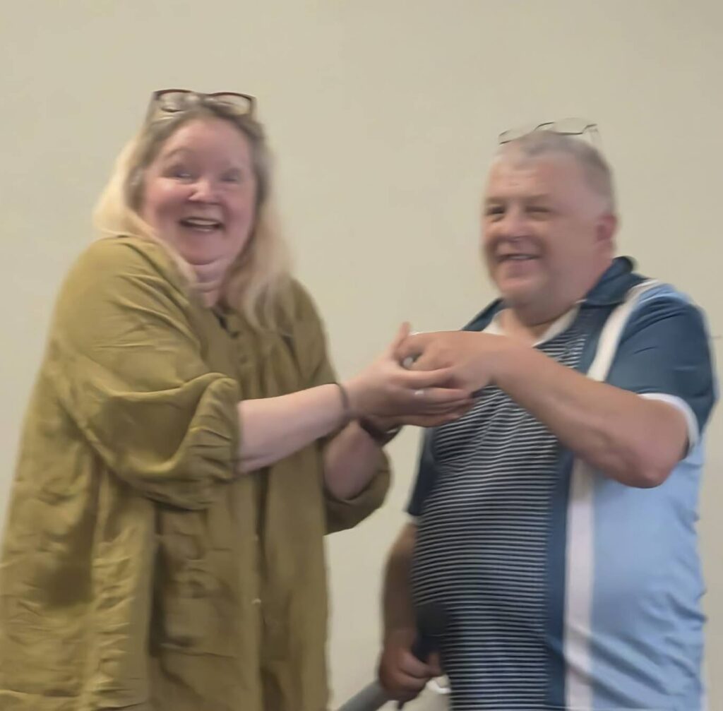 Photo from Rob's Bingo: Sally accepts an amazing £1148 from Robert, at Walsoken Village Hall