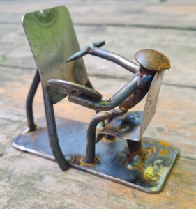 Photo of Mick metal sculpture of an artist sitting at an easel (a gift for Sally)